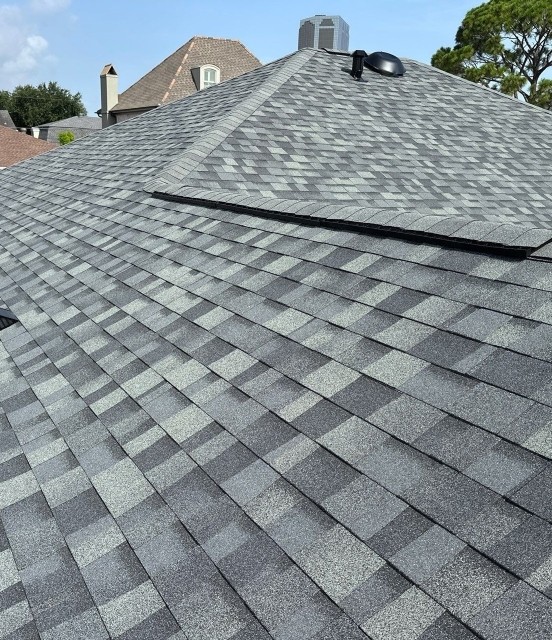 New roofing shingles on a residential roof with siding in Harahan, LA, showcasing quality installation and FORTIFIED roofing features by Augustino Brothers, Inc.